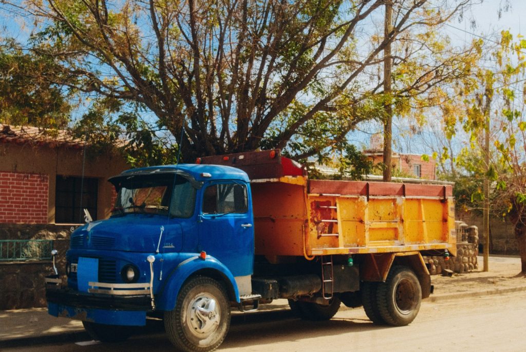 a truck parked in front of a tree